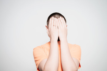 Man closes eyes with her hands