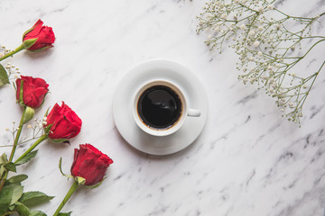 Roses and coffee flat lay on marble table