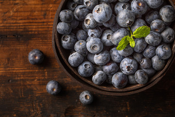 Blueberries or huckleberries in a coconut bowl, seen from above