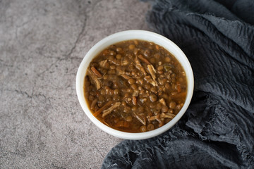 A bowl of lentil soup with chicken, Mediterranean soup with thick stew like broth. 