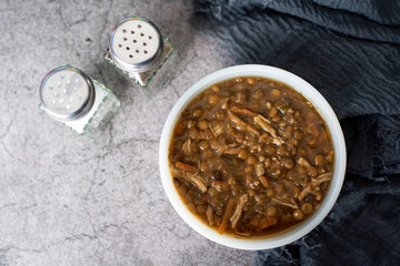 A bowl of lentil soup with chicken, Mediterranean soup with thick stew like broth. 