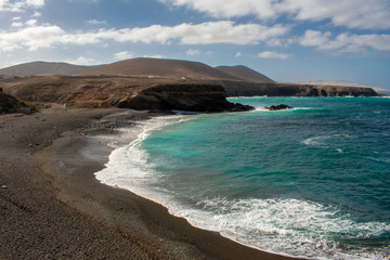 Fototapeta na wymiar Aerial view of Black Sandy Beach, Coast of Atlantic Ocean and Cliffs in Ajuy, Furteventura, Canary Islands, Spain 