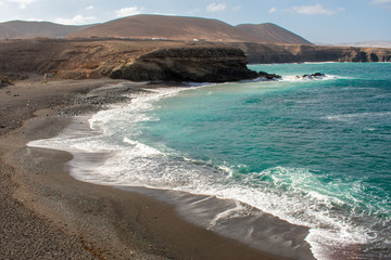 Aerial view of Black Sandy Beach, Coast of Atlantic Ocean and Cliffs in Ajuy, Furteventura, Canary Islands, Spain 