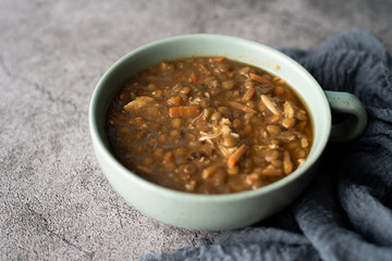 A bowl of lentil soup with chicken, Mediterranean soup with thick stew like broth. 