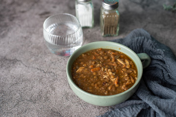 A bowl of lentil soup with chicken, Mediterranean soup with thick stew like broth. 
