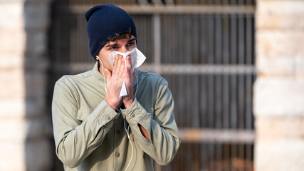 Sick boy blowing his nose in a handkerchief, cold, virus crown, flu