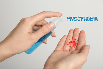 Woman applying antiseptic gel on hands, closeup. Mysophobia