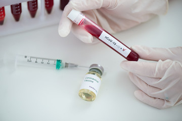 Test tubes with blood sample Covid-19 coronavirus. Vaccine and syringe injection It use for prevention, immunization and treatment from COVID