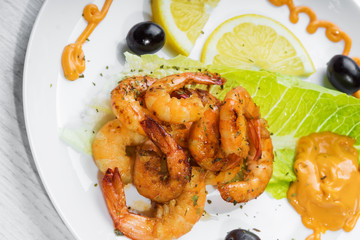 Fried langostins in a white plate