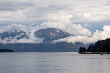 Beautiful morning light hitting the water snow cap mountains in the background in Juneau, Alaska 