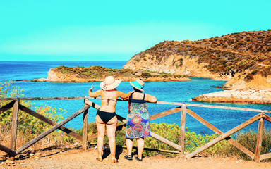 Women in Chia Beach and Mediterranean Sea South Sardinia Italy reflex
