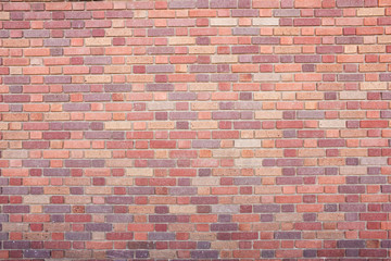 A view of a retro brick wall facade on a building, as a background.
