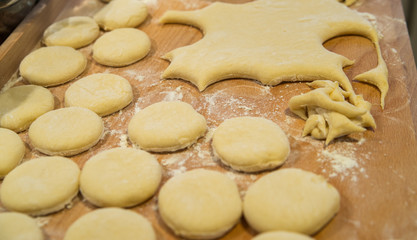 Fototapeta na wymiar close up shaped dough on wooden table, 