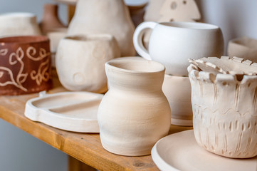 raw ceramic cups on the shelf