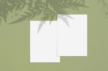 Blank white vertical paper sheet 5x7 inches with shadow overlay. Modern and stylish greeting card or wedding invitation mock up.