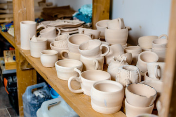 Fototapeta na wymiar raw clay cups on the shelf