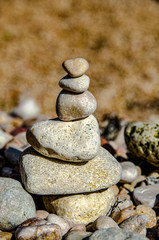 Fototapeta na wymiar Pebble stone pyramid on the beach.