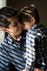Fototapeta premium Father and son close together at home