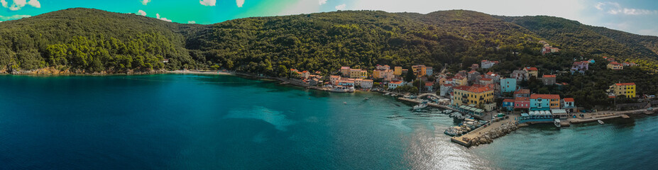 Aerial panorama of adriatic coastal city of Valun on Croatian island of Cres. Beautiful small picturesque village at the beach in the summer sun.