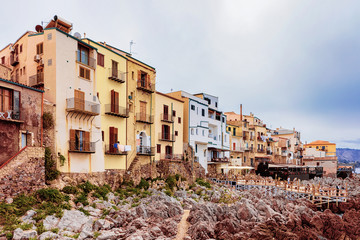 Fototapeta na wymiar Old houses on Rocky Coast at Cefalu Sicily