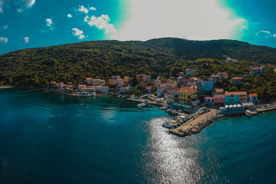 Aerial panorama of adriatic coastal city of Valun on Croatian island of Cres. Beautiful small picturesque village at the beach in the summer sun.