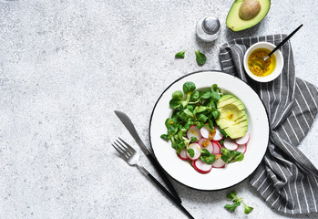 Corn salad with avocado and radish with mustard and honey sauce. Vitamin salad, top view.
