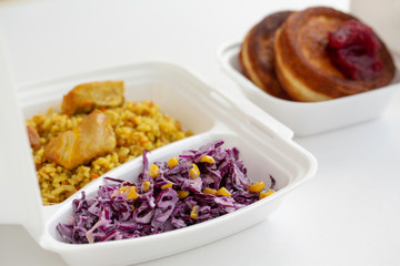 food delivery in lunch boxes against coronavirus. Food to go. polypropylene boxes. Chicken and rice. Cabbage salad. 