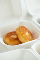 food delivery in lunch boxes against coronavirus. Food to go. polypropylene boxes.  hands in protective gloves. homemade pancakes.