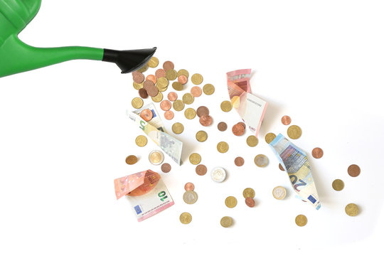 Green watering can is pouring Euro coins and banknotes, symbol for corona bonds, dumping money at random is called watering can principle, isolated, white background, copy space