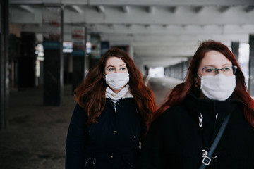 Virus epidemic in Europe. People wearing face masks on city street.