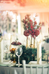 Decoration for the holiday table. Spruce branch and berries of viburnum.