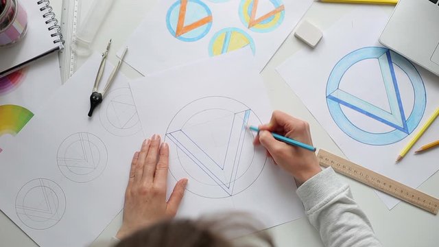 Designer illustrator draws sketches of logos for the brand.