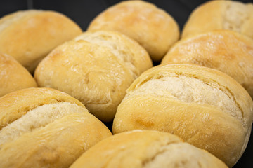 loaves of crispy golden bread, freshly made in a bakery