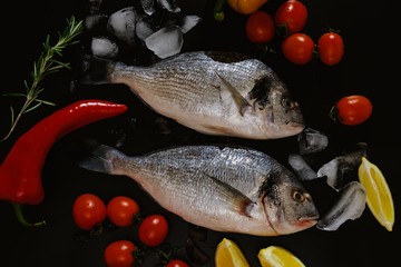 Fish seafood dorado, raw food on black background, dinner.