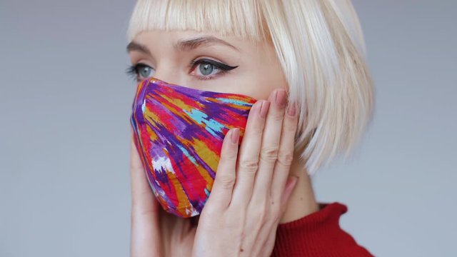 Woman wears fashionable colorful handmade protective face mask