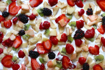 Making yogurt bark. Pieces of fruit in a yogurt before freezing. Top view.