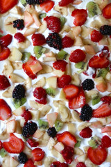 Making yogurt bark. Pieces of fruit in a yogurt before freezing. Top view.