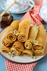 Sweet thin pancakes crepes served with honey