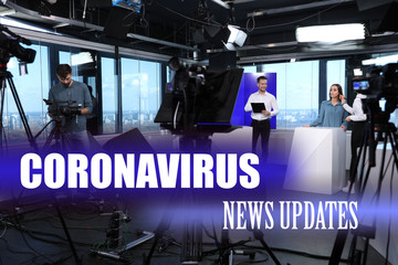 Presenters and video camera operator working in studio. Coronavirus pandemic - latest updates