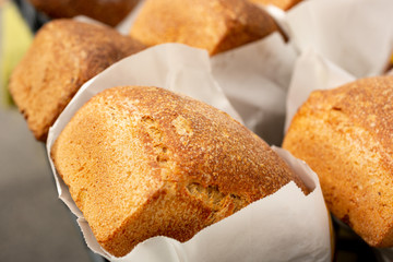 A closeup view of several fresh rustic loaves of bread, on display at a local bakery.