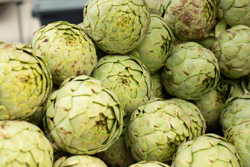 Fototapeta premium A view of several artichokes on display at a local farmers market.