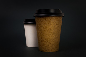 Take away coffee cups with lids on black background.