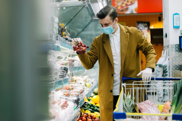 a man in a medical mask buys food at a grocery store. Coronavirus, virus, infection, epidemic, pandemic. RUSSIA, RUSSIA-MARCH 19, 2020. OBNINSK