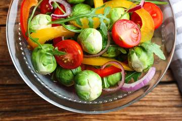 Tasty salad with Brussels sprouts on wooden table, flat lay