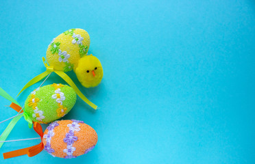 Colorful easter egg on blue pastel color background with space for text.