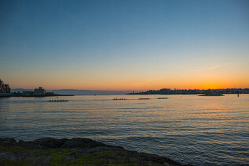 Outrigger Canoes Heading Towards the Sunset