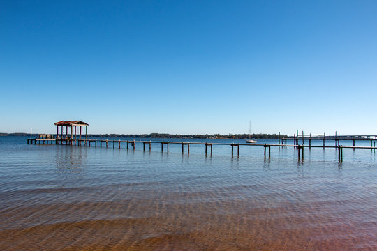 boat dock pier in perdido bay lillian alabama clear blue sky