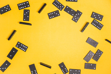 A black dominoes on yellow background with empty space for your text