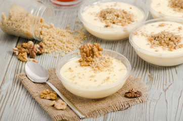 Turkish desert keskul rice pudding with hazelnut powder stock photo