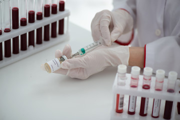 Test tubes with blood sample Covid-19 coronavirus. Vaccine and syringe injection It use for...